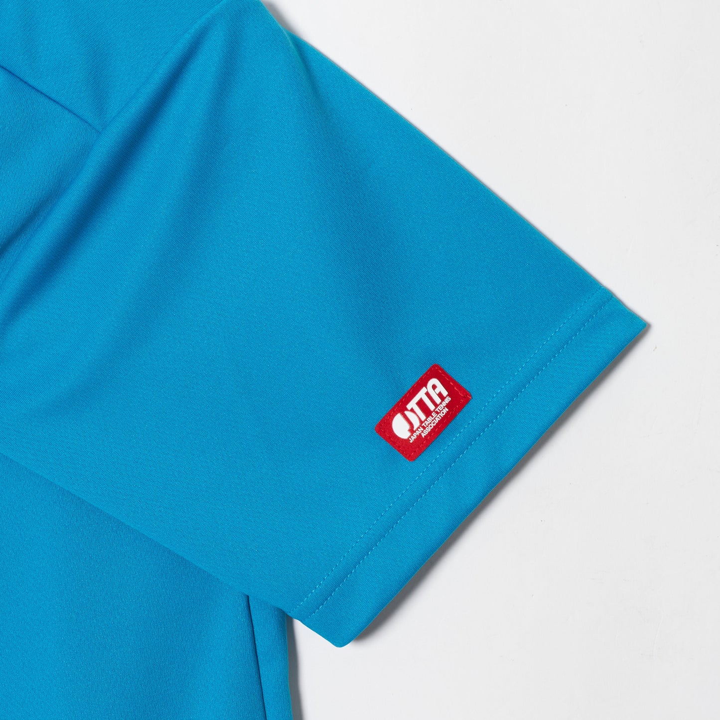 Rallys Tシャツ(ターコイズブルー・ロゴ大)|公式戦でも使える卓球Tシャツ